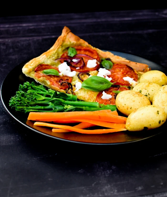 Vegan Puff Pastry Tomato, Onion & Feta Tart Vegan Puff Pastry Tomato, Onion & Feta Tart topped with crumbled vegan feta and fresh basil leaves